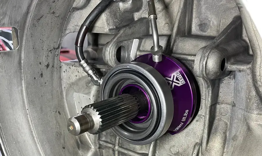 Porsche 996/997 Twin Plate Clutch Kit - Complete Upgrade Package Complete twin-plate clutch upgrade kit for Porsche 996/997 showing clutch assembly, flywheel, slave cylinder, and installation components laid out on workbench